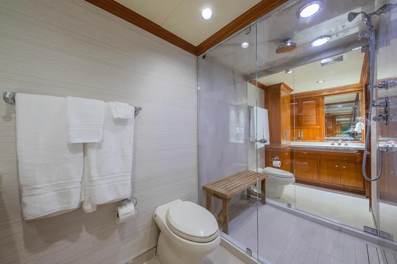 Slide: The Image of Luxurious bathroom in 1998 Burger Raised Pilothouse yacht with glass shower and wooden accents. - 46