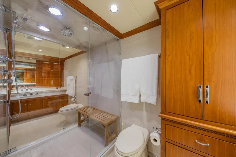 Slide: The Image of Luxurious bathroom in 1998 Burger Raised Pilothouse yacht with glass shower and wooden cabinetry. - 47