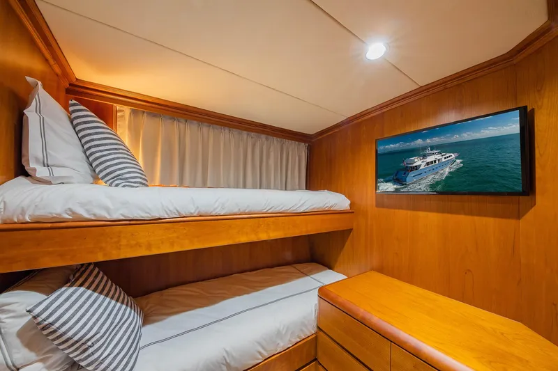 Slide: The Image of Cozy cabin with bunk beds and yacht photo on wall, 1998 Burger Raised Pilothouse. - 48