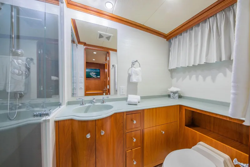 Slide: The Image of Luxurious bathroom in 1998 Burger Raised Pilothouse yacht with wood cabinetry and modern fixtures. - 49