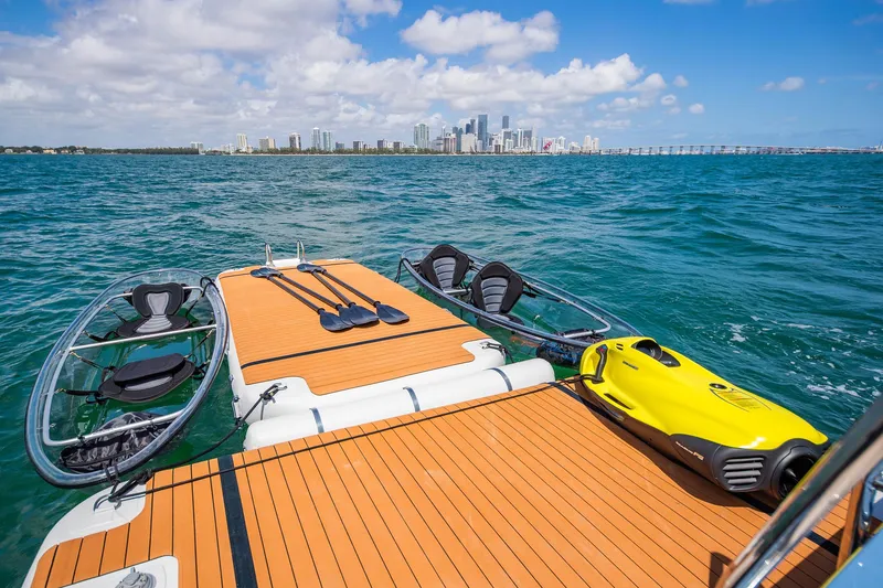 Slide: The Image of Luxury yacht deck with water sports gear, ocean view, city skyline in background. - 9