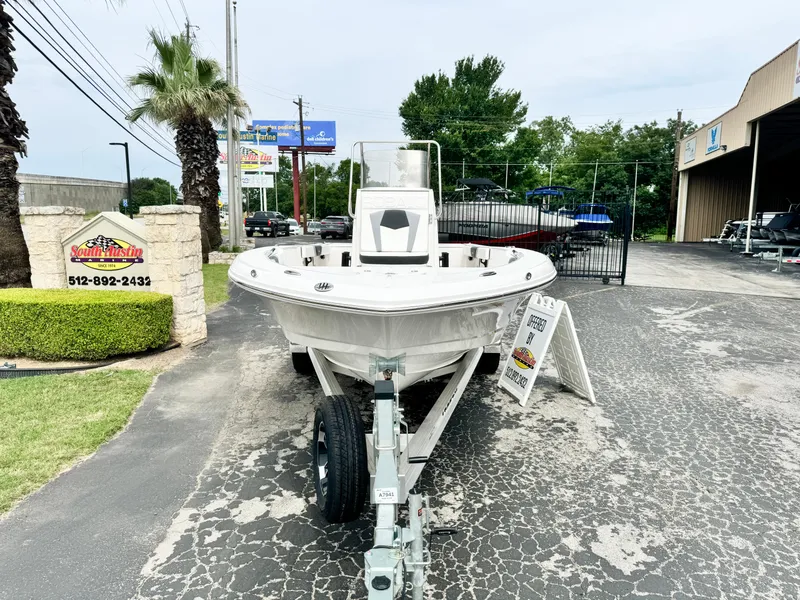 Slide: The Image of 2024 Robalo 226 Cayman boat on trailer at dealership, front view. - 18