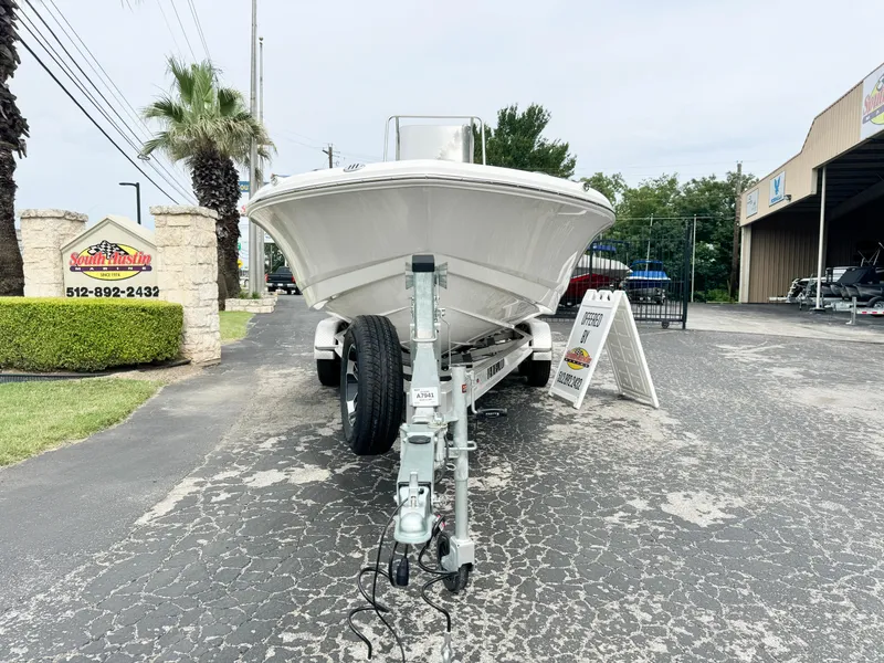Slide: The Image of 2024 Robalo 226 Cayman boat on trailer at dealership, front view. - 19