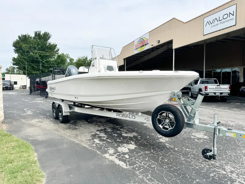 Slide: The Image of 2024 Robalo 226 Cayman boat on trailer outside dealership. - 20