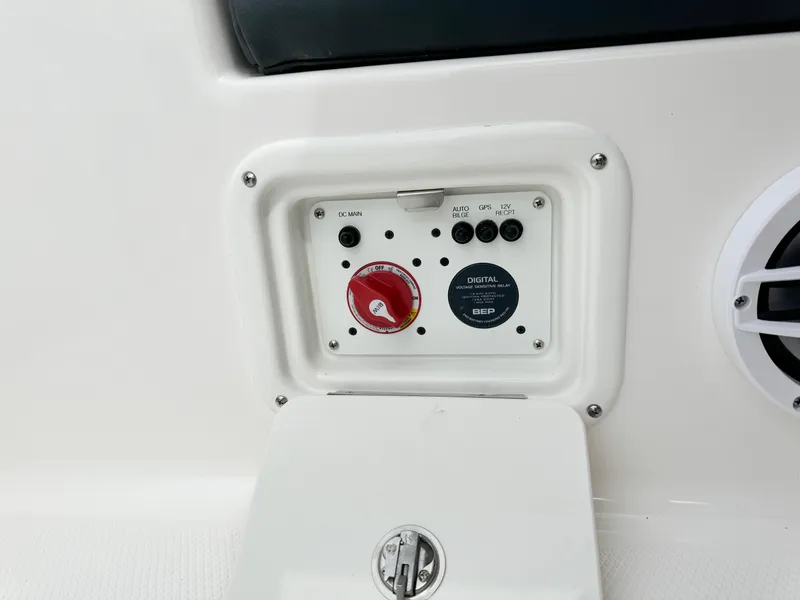Slide: The Image of 2024 Robalo 226 Cayman boat control panel with switches and dials. - 30