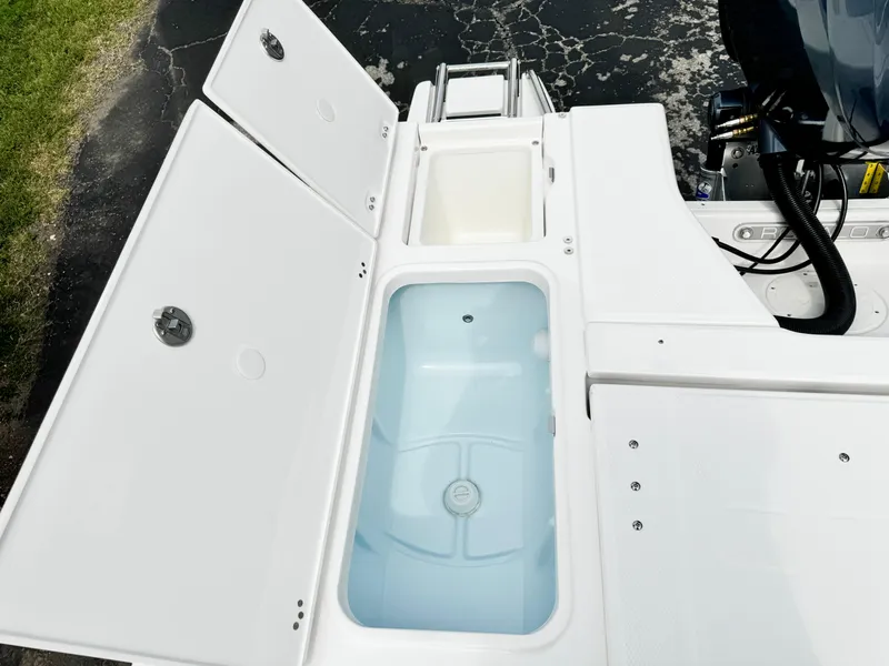 Slide: The Image of 2024 Robalo 226 Cayman boat storage compartments and livewell. - 31
