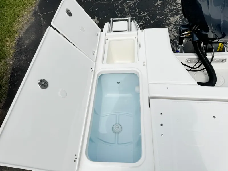 Slide: The Image of 2024 Robalo 226 Cayman boat storage compartments and livewell. - 32