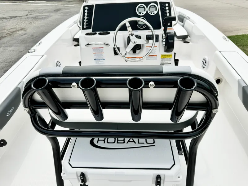 Slide: The Image of 2024 Robalo 226 Cayman boat interior with steering console and rod holders. - 35