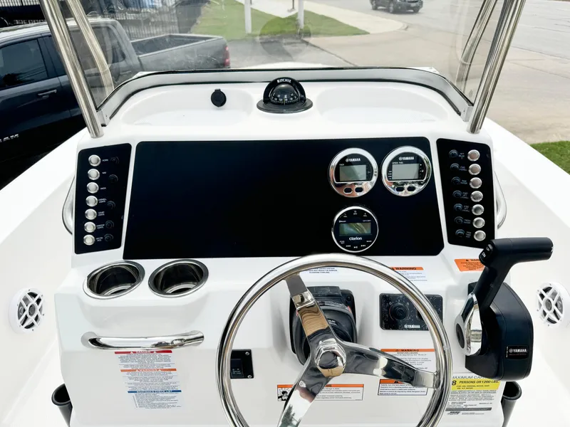 Slide: The Image of 2024 Robalo 226 Cayman boat dashboard with steering wheel and control panel. - 40