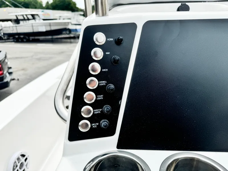 Slide: The Image of 2024 Robalo 226 Cayman boat control panel with switches and buttons. - 41