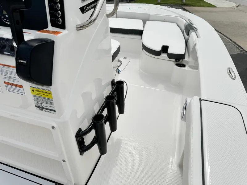 Slide: The Image of 2024 Robalo 226 Cayman boat interior with rod holders and seating. - 48