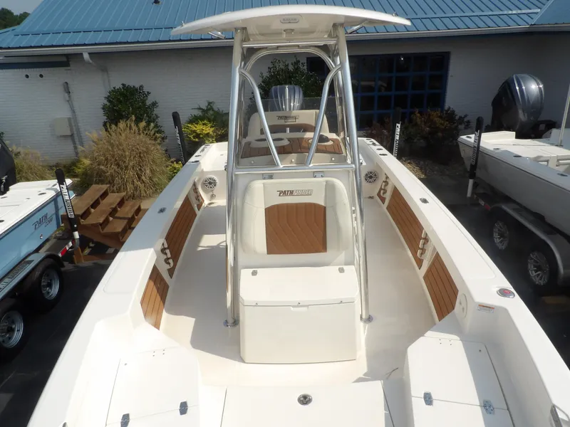 Slide: The Image of 2024 Pathfinder 2400 TRS boat with center console and seating, displayed outdoors. - 10