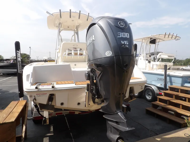 Slide: The Image of 2024 Pathfinder 2400 TRS boat with Yamaha 300 V6 engine, docked outdoors. - 13