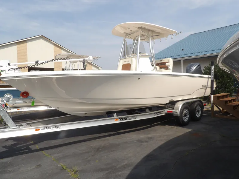 Slide: The Image of 2024 Pathfinder 2400 TRS boat on trailer, parked outdoors. - 2