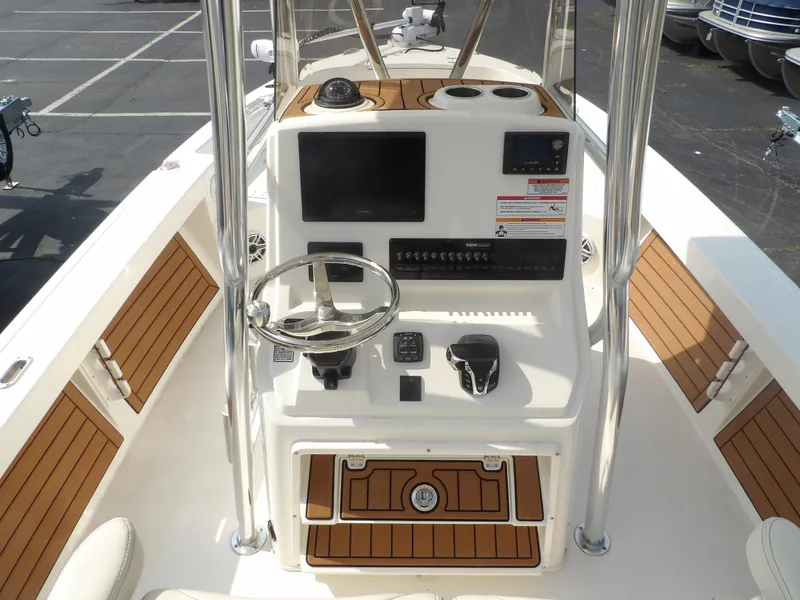 Slide: The Image of 2024 Pathfinder 2400 TRS boat console with steering wheel and controls. - 3