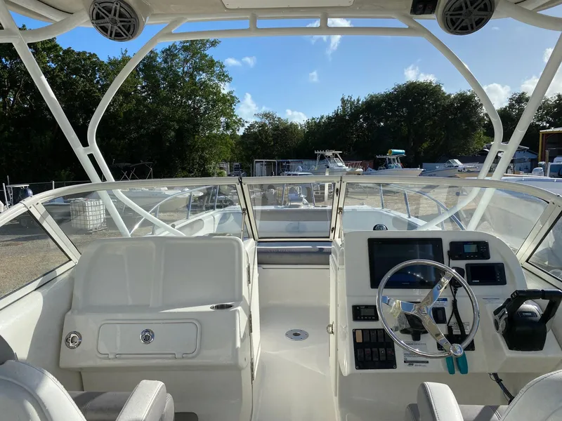 Slide: The Image of 2018 World Cat 255 DC boat interior with steering wheel and dashboard controls. - 17
