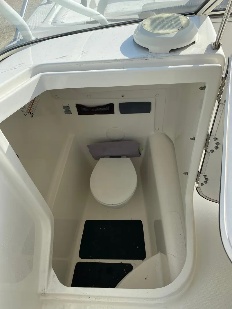 Slide: The Image of 2018 World Cat 255 DC boat interior with compact marine toilet. - 2
