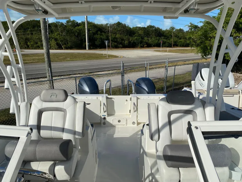 Slide: The Image of 2018 World Cat 255 DC boat interior with seating and dual engines. - 3