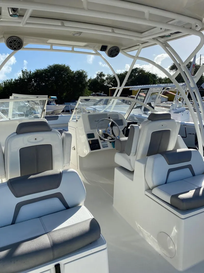 Slide: The Image of 2018 World Cat 255 DC boat interior with modern seating and steering console. - 5