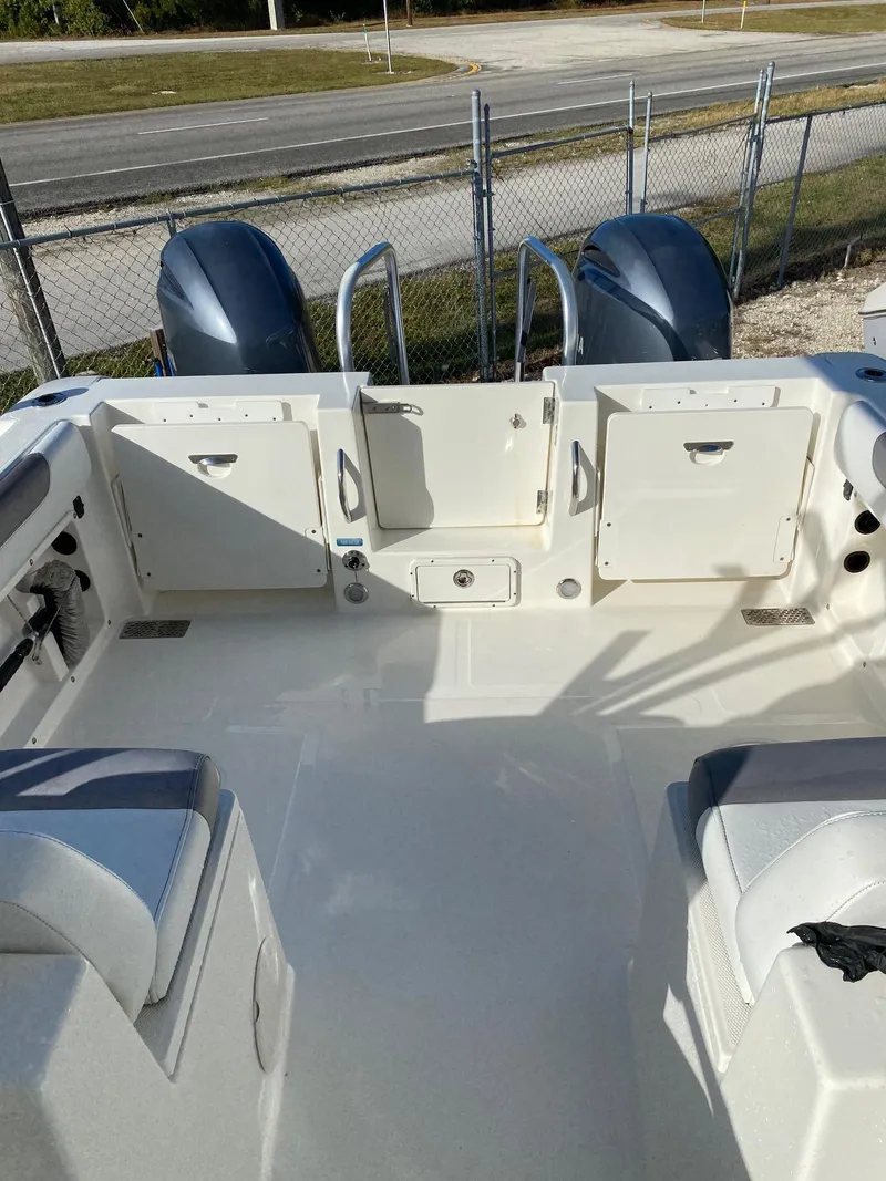 Slide: The Image of 2018 World Cat 255 DC boat interior with dual engines and seating. - 6