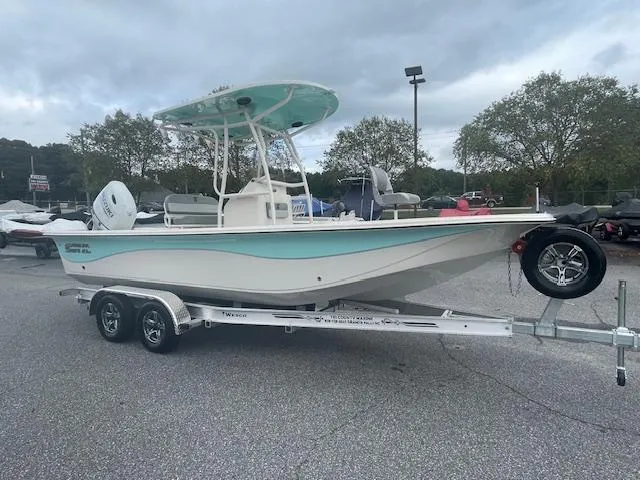 The Image of 2025 Carolina Skiff 23LS boat on trailer, parked outdoors under cloudy sky. - 0