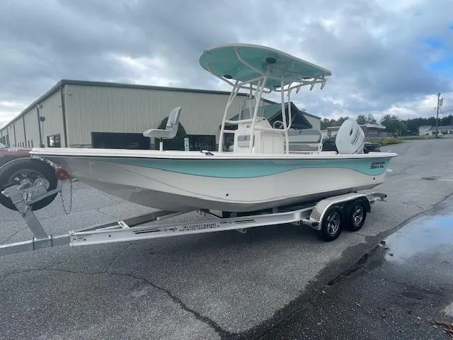 Slide: The Image of 2025 Carolina Skiff 23LS boat on trailer, parked outdoors under cloudy sky. - 1