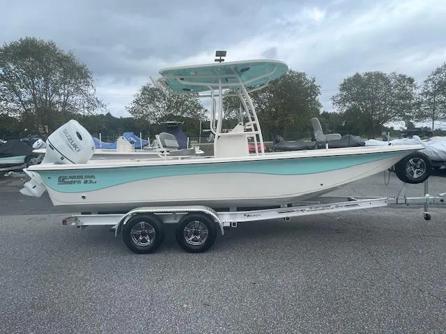 Slide: The Image of 2025 Carolina Skiff 23LS boat on trailer, parked outdoors. - 3