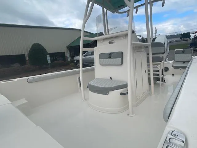 Slide: The Image of 2025 Carolina Skiff 23LS boat interior with seating and console, under cloudy sky. - 5