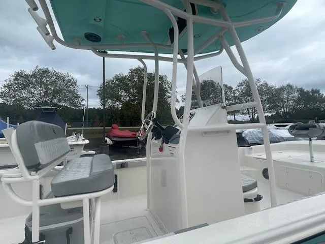 Slide: The Image of 2025 Carolina Skiff 23LS boat interior with seating and console, docked outdoors. - 7