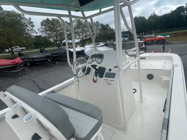 Slide: The Image of 2025 Carolina Skiff 23LS boat interior with steering console and seating. - 8