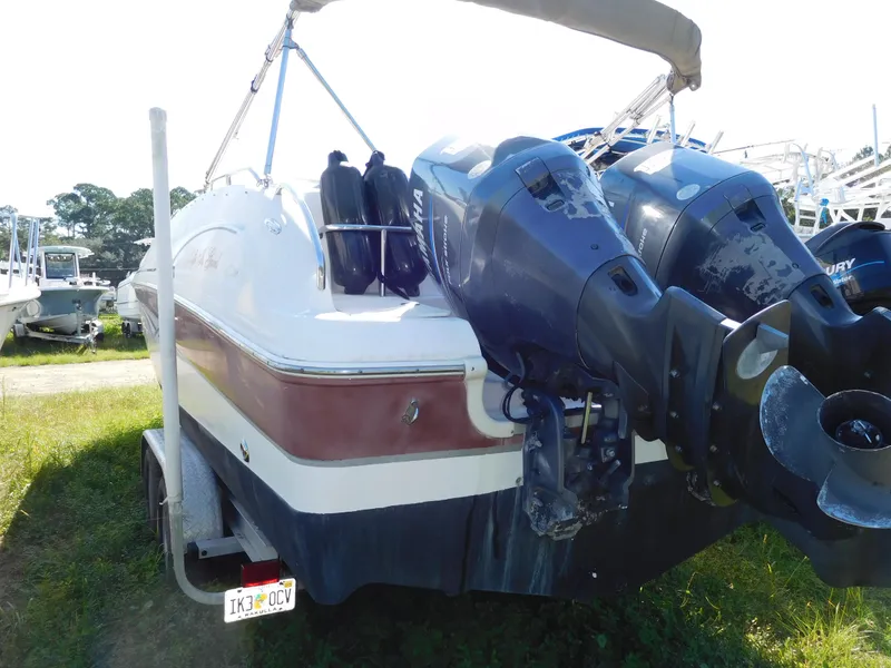 Slide: The Image of 2006 Hurricane SD 260 boat with dual outboard motors on a trailer. - 2