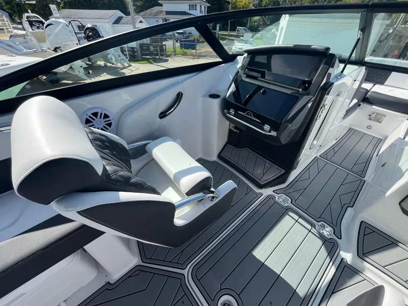 Slide: The Image of 2025 Monterey M-45 boat interior with modern dashboard and seating. - 13