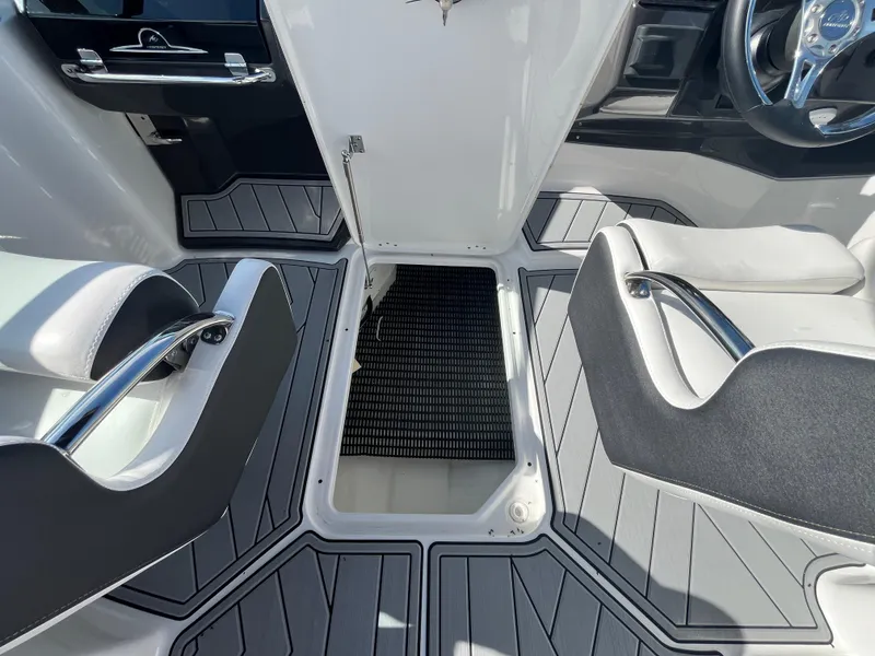 Slide: The Image of 2025 Monterey M-45 boat interior with open storage compartment and sleek seating. - 19