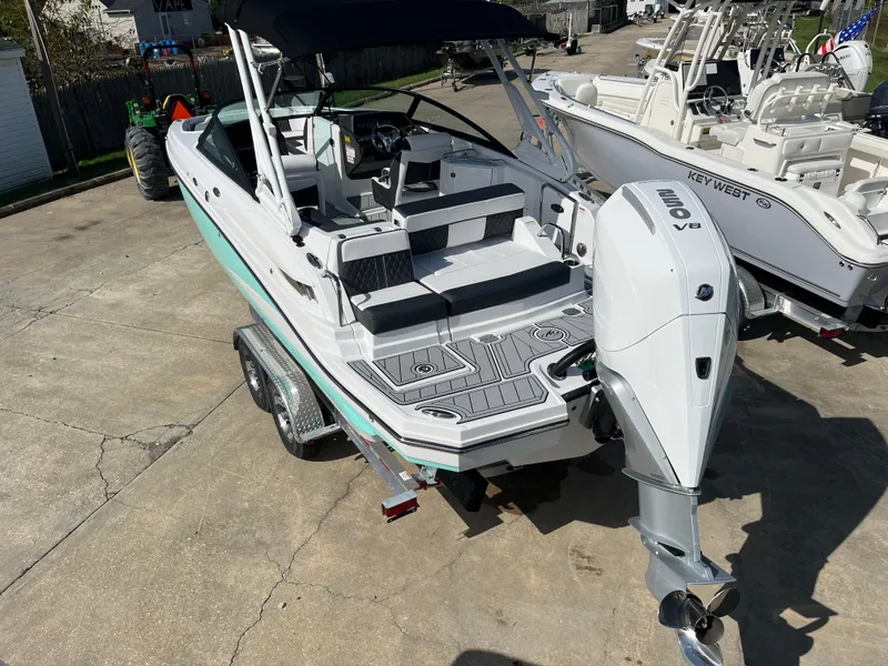 Slide: The Image of 2025 Monterey M-45 boat on trailer, featuring sleek design and powerful outboard motor. - 2