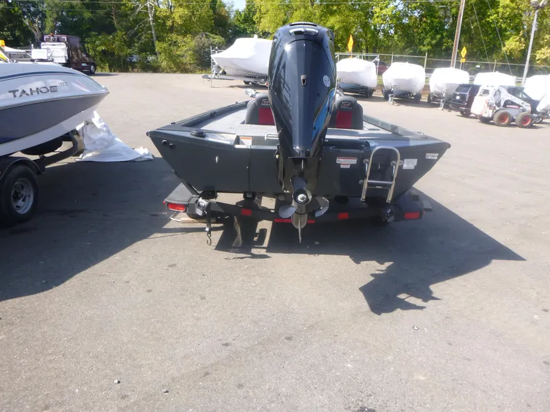 Slide: The Image of 2024 Ranger RT188C boat with outboard motor in a parking lot. - 10