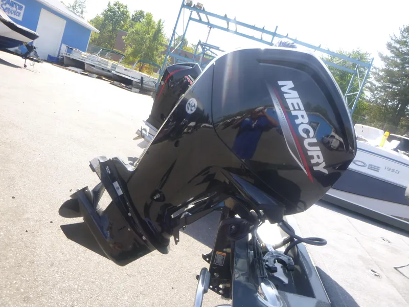 Slide: The Image of 2024 Ranger RT188C boat with Mercury outboard motor in a sunny outdoor setting. - 12