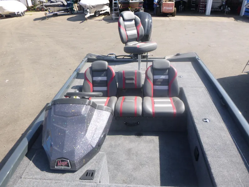 Slide: The Image of 2024 Ranger RT188C boat interior with gray and red seating, spacious deck, and windshield. - 19