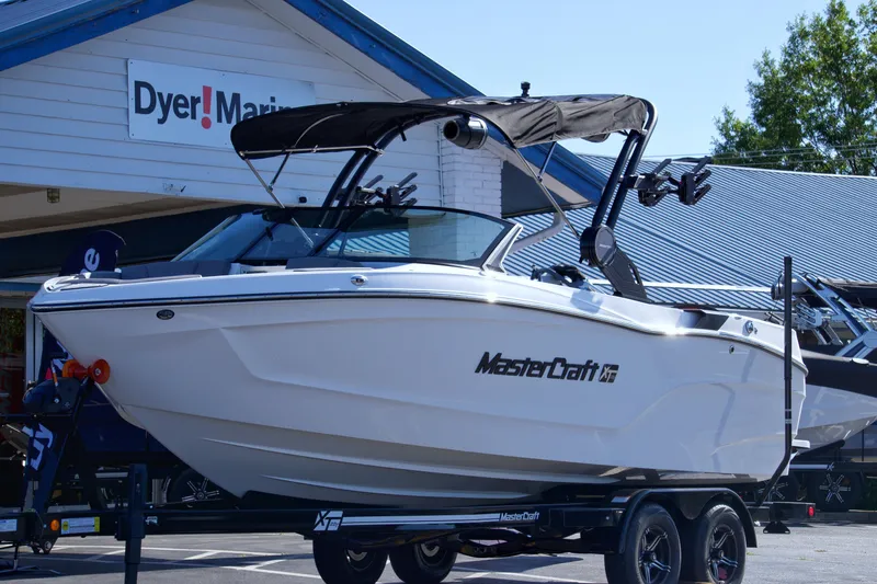 Slide: The Image of 2024 MasterCraft XT22T boat displayed at Dyer Marine dealership. - 4