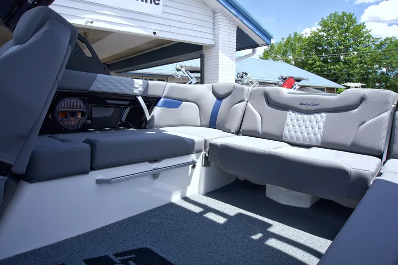 Slide: The Image of 2024 MasterCraft XT22T boat interior with gray seating and modern design. - 9