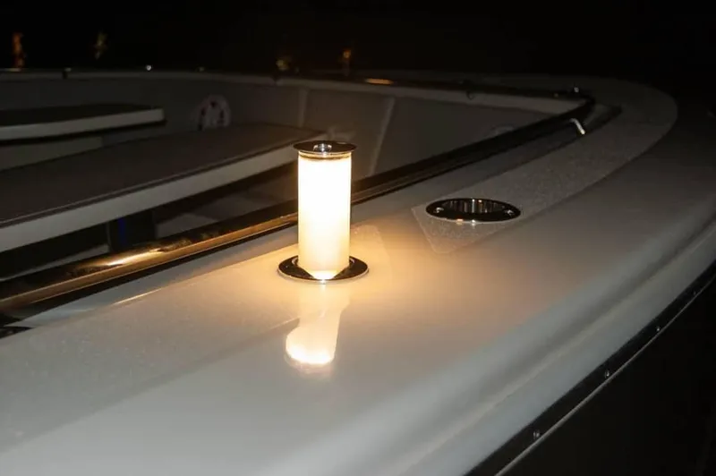 Slide: The Image of 2025 Scout 530 LXF boat deck with illuminated light fixture at night. - 22