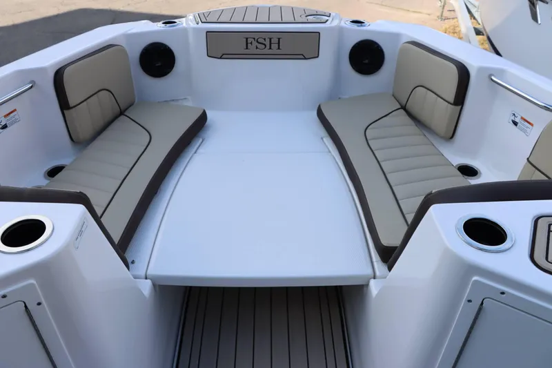 Slide: The Image of 2025 Yamaha Boats 222 FSH Sport E interior with cushioned seating and cup holders. - 6