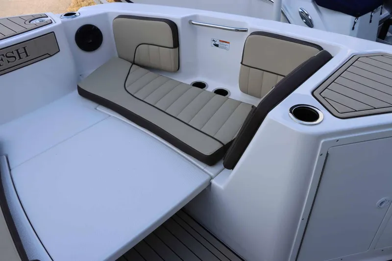 Slide: The Image of 2025 Yamaha Boats 222 FSH Sport E interior seating with cup holders and cushioned seats. - 7