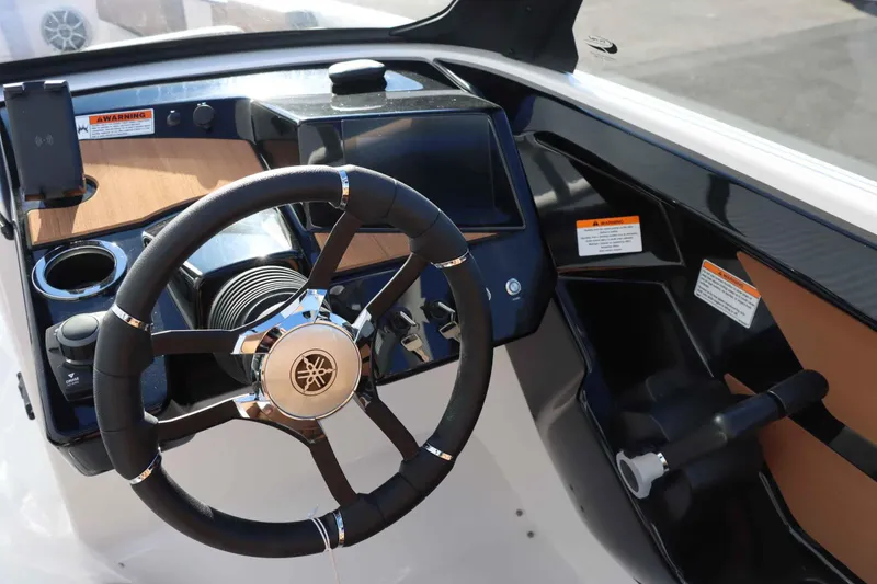 Slide: The Image of 2025 Yamaha Boats 222S steering wheel and dashboard, featuring modern controls and sleek design. - 11