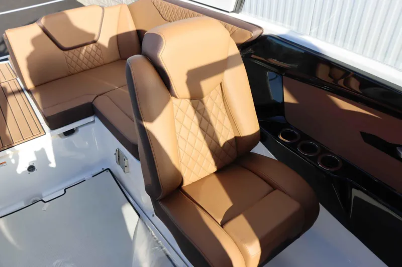 Slide: The Image of 2025 Yamaha Boats 222S interior with luxurious tan leather seating and cup holders. - 15