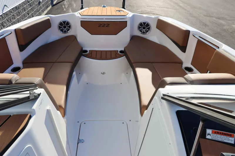 Slide: The Image of 2025 Yamaha Boats 222S interior with brown seating and modern design. - 16