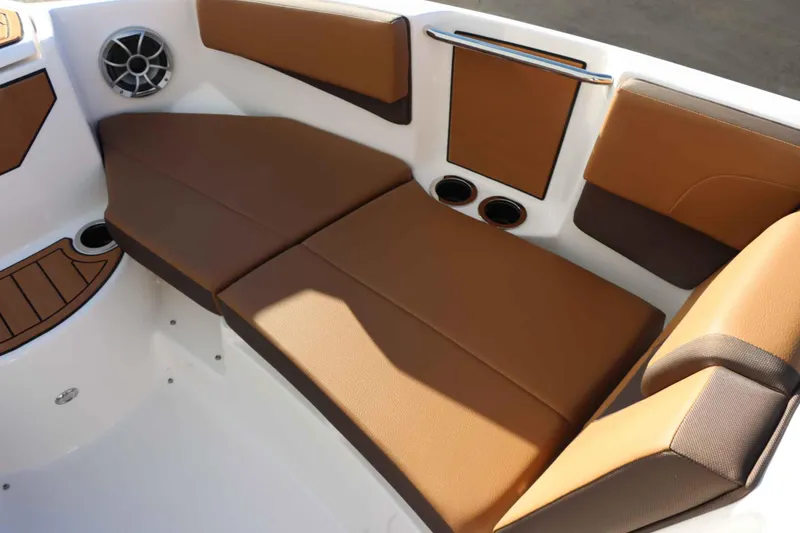Slide: The Image of 2025 Yamaha Boats 222S interior with brown cushioned seating and speaker. - 18