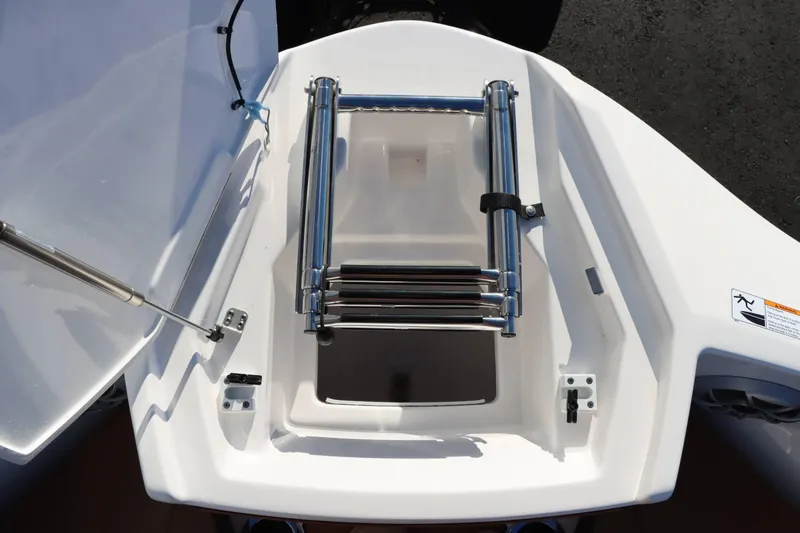 Slide: The Image of 2025 Yamaha Boats 222S with foldable stainless steel ladder in storage compartment. - 19