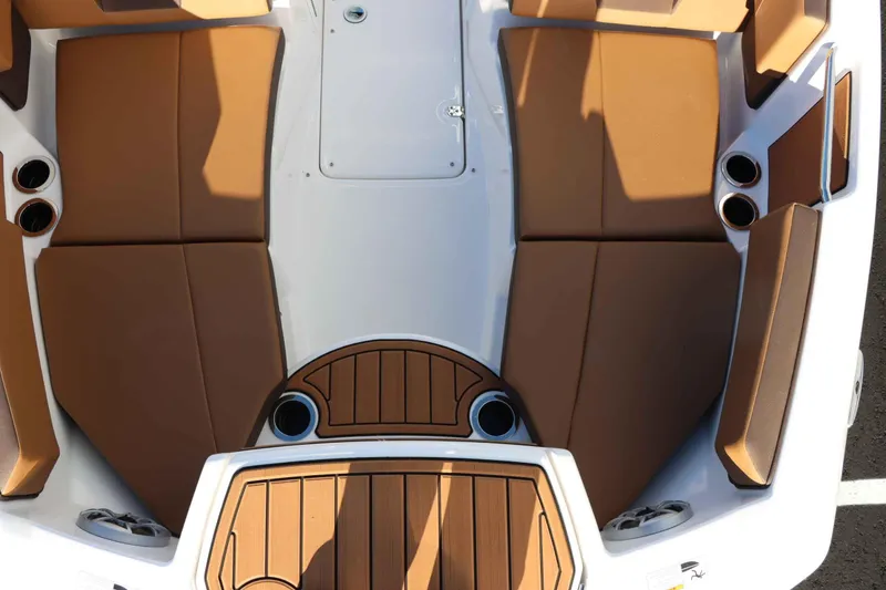 Slide: The Image of 2025 Yamaha Boats 222S interior with brown seating and cup holders. - 20