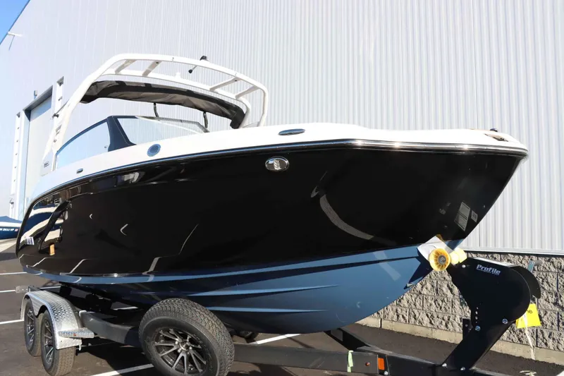 Slide: The Image of 2025 Yamaha Boats 222S on trailer, sleek black and white design. - 3