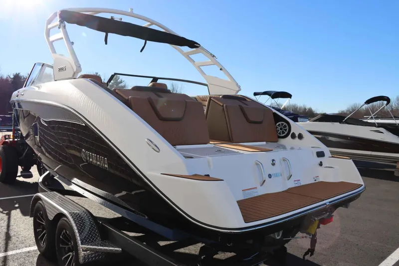 Slide: The Image of 2025 Yamaha Boats 222S on trailer, sleek design, sunny day. - 5